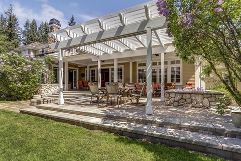 Outdoor table with three chairs on backyard patio