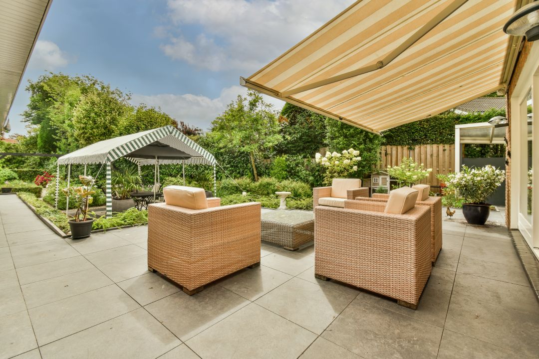 Patio with chairs and floor made of stone pavers